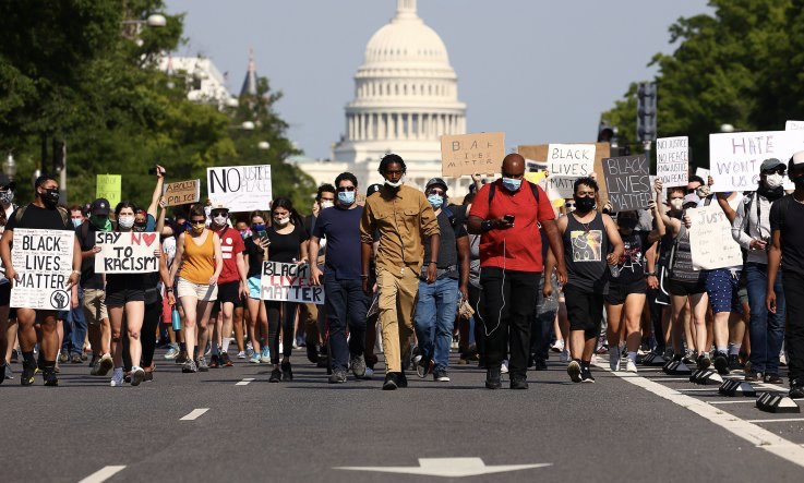 Demonstrators march down Pennsylvania Avenue to protest against police brutality and the death of George Floyd, on June 3, 2020 in Washington, DC.