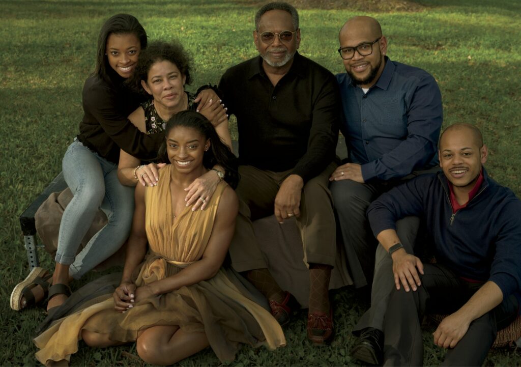 Biles (seated, wearing an Alaïa dress), photographed in February 2020 with her family in Spring, Texas. From left: Simone’s younger sister, Adria, her parents, Nellie and Ron, and their sons, Ron II and Adam.